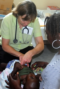 Doctor treats baby at La Colline clinic
