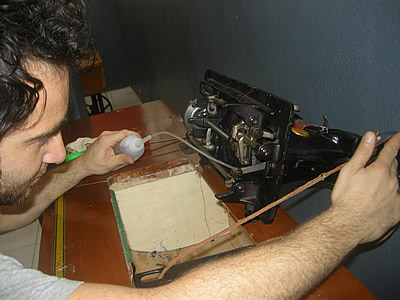 Mike Martone oils sewing machine